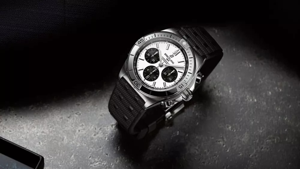 a watch sitting on top of a black bag