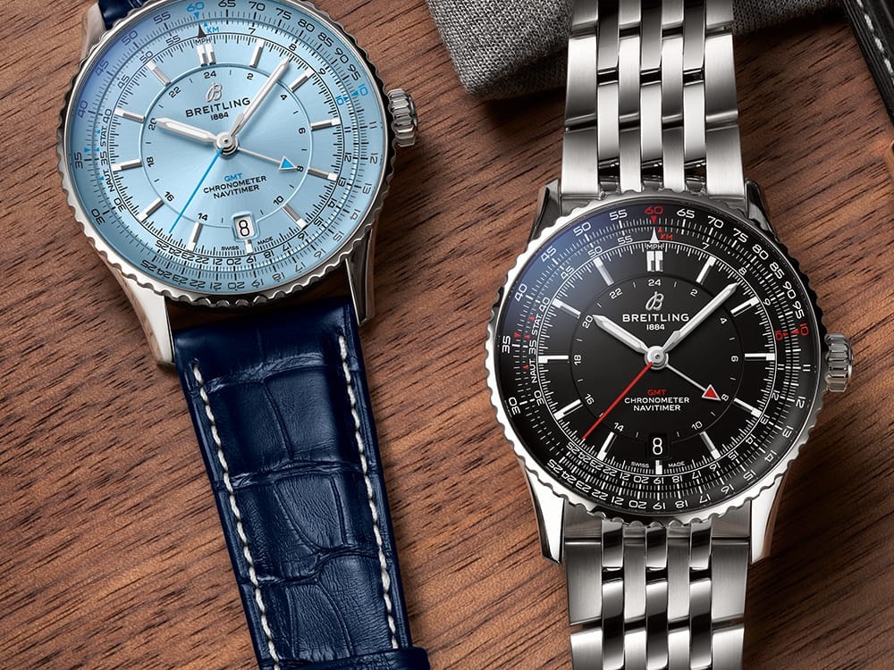 Navitimer with a light blue dial and Navitimer with a black dial on a table.