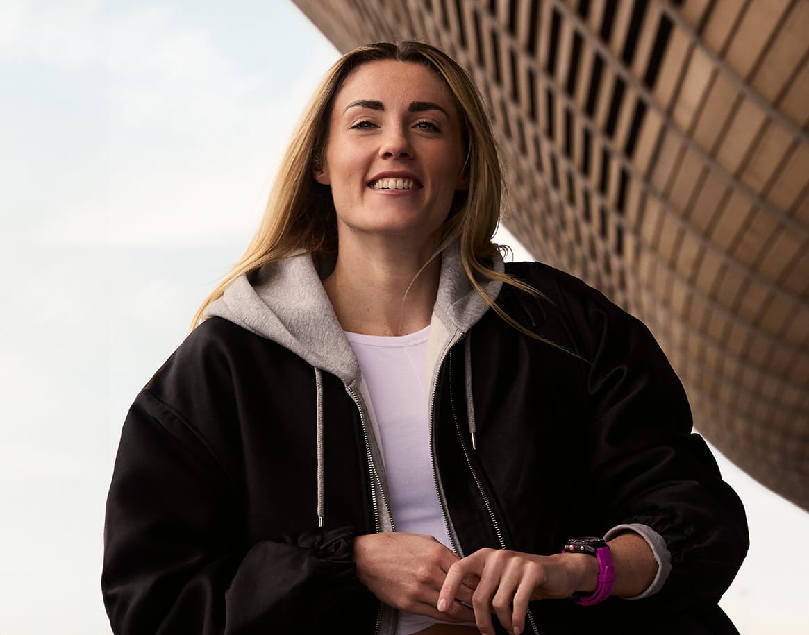 a woman standing in front of a tall building
