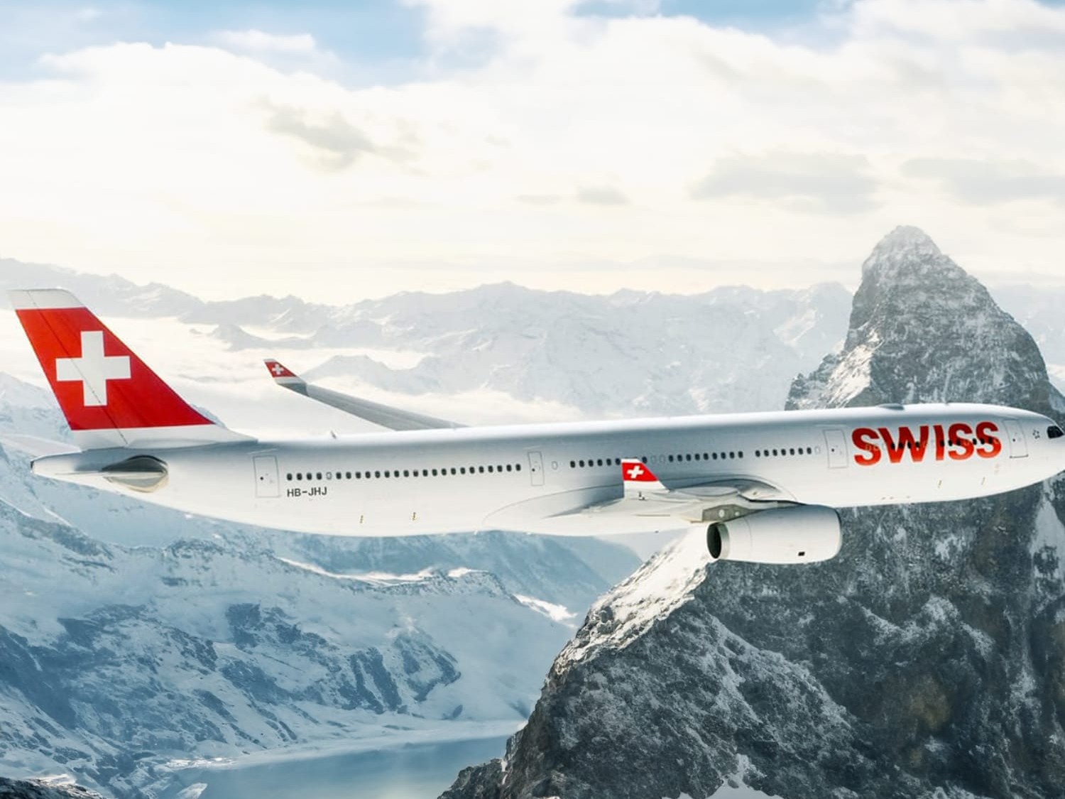 A SWISS aircraft flies over the Alps and represents the partnership between Breitling and SWISS International Air Lines.