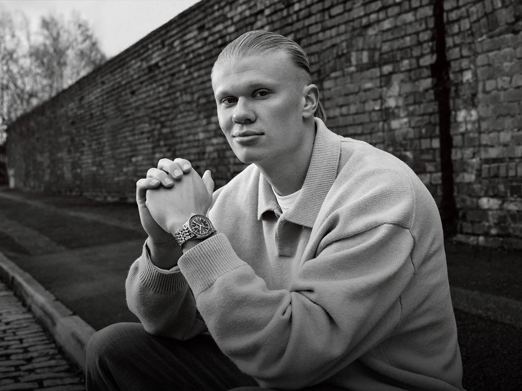 a black and white photo of a man in a sweater