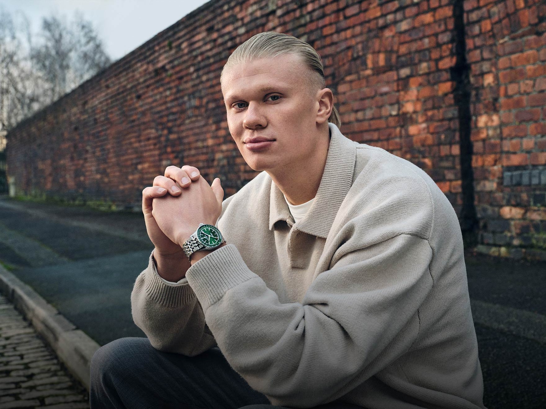 a black and white photo of a man in a sweater