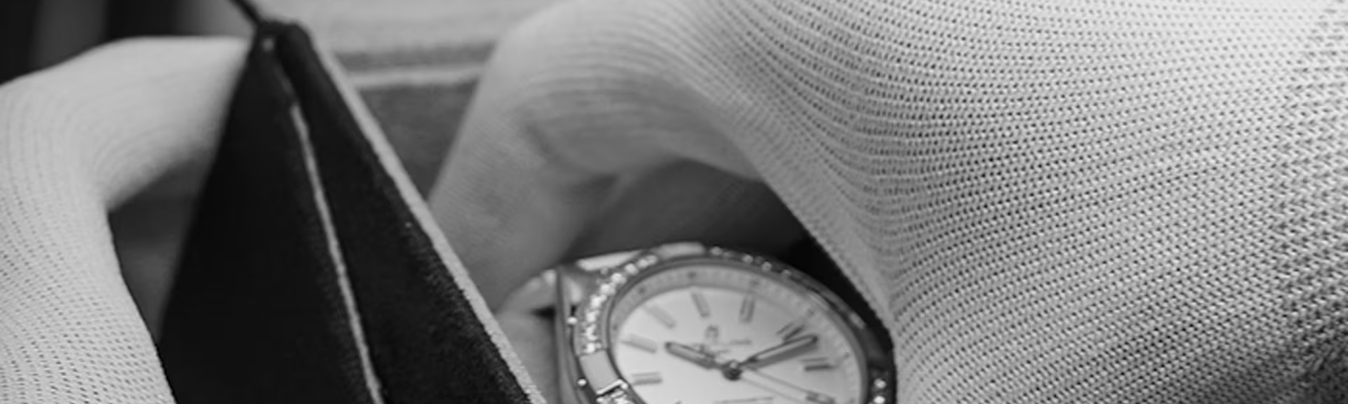 Carefully and with gloves on, a Breitling watch is taken out of its packaging.