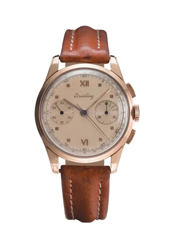 a rose gold watch with brown leather strap