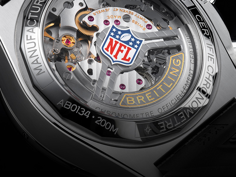 Close-up of a Breitling watch with the NFL logo on the dial
