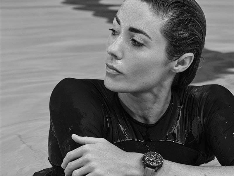 a black and white photo of a woman in the water