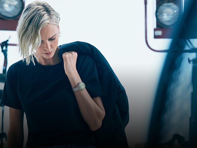 Actress Charlize Theron wears a Breilting watch on her wrist.