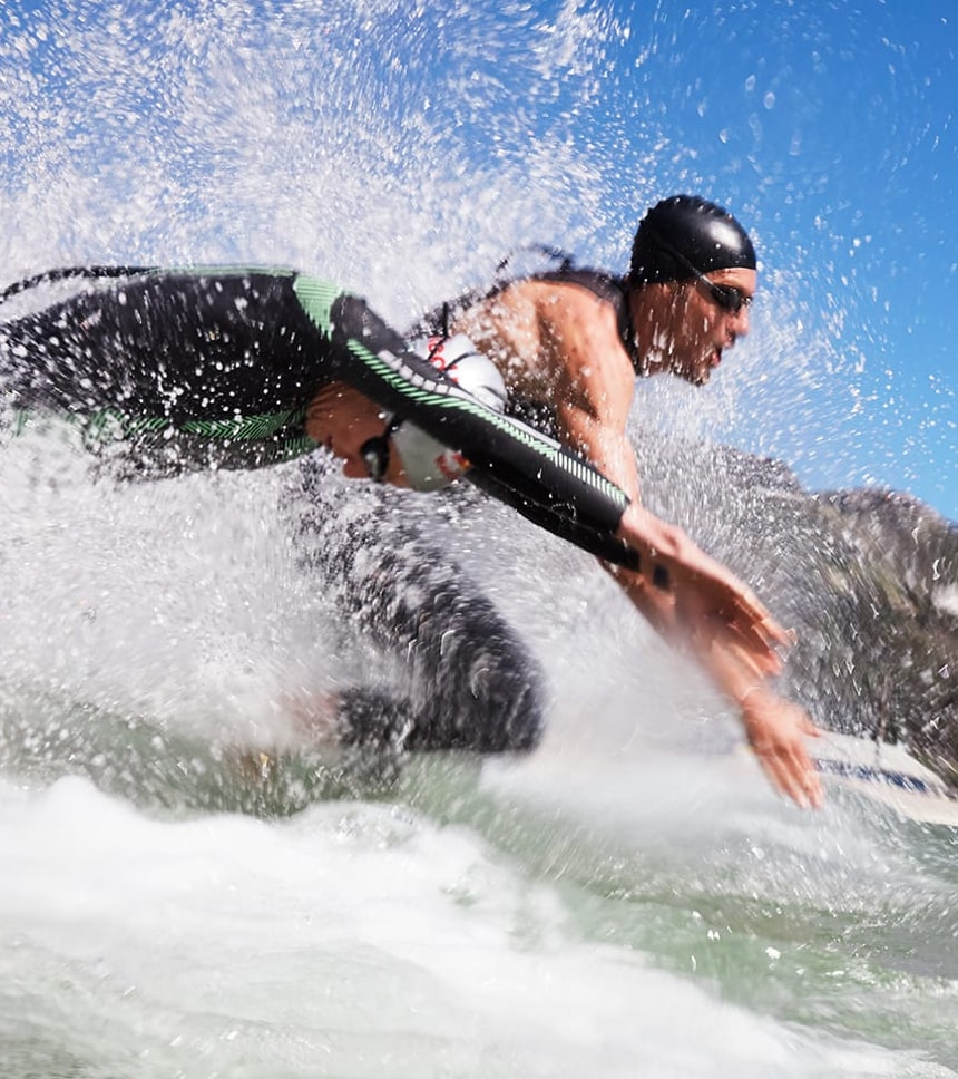 Two Ironman athletes, symbolizing the partnership between Breitling and Ironman, jump into the water.