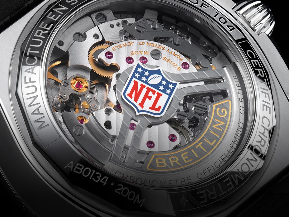 Close-up of a Breitling watch with the NFL logo on the dial