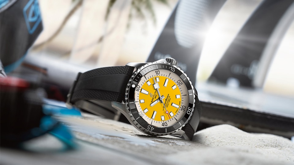a watch sitting on top of a surfboard