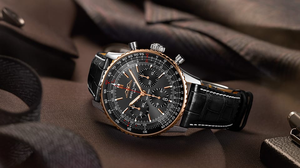 a black and gold watch on a brown background